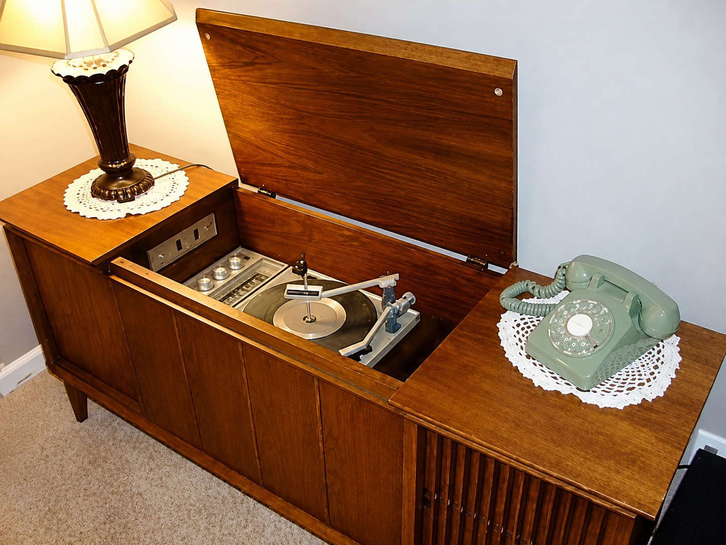 Radiola de madera con tocadiscos y un disco de vinilo, como la de la casa de la infancia